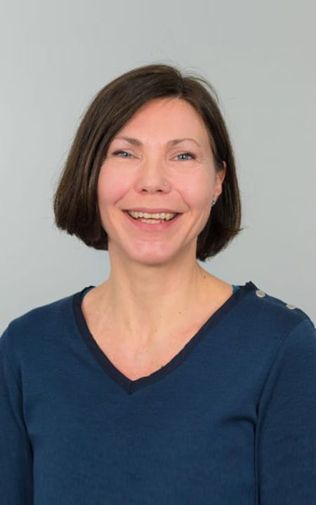Monika-Lie-Larsen_500x800.jpg a woman in a blue shirt and smiling at the camera