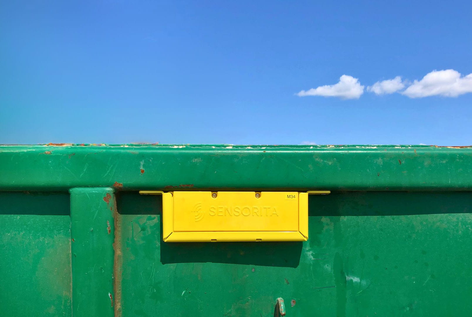 outdoor green bin building sitting blue water bench sign empty wooden city large street boat ocean